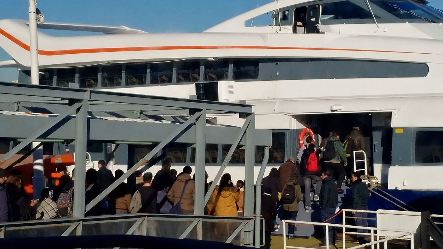 Passengers prepare to board a ferry