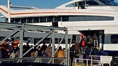 Passengers prepare to board a ferry