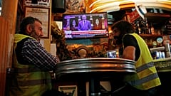 Christophe Chalencon (left) watching a televised speech by France's PM