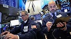 Traders work on the floor of the NYSE in New York