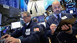 Traders work on the floor of the NYSE in New York