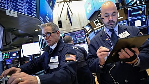 Traders work on the floor of the NYSE in New York