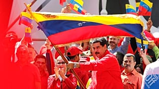 Maduro waves a Venezuelan flag