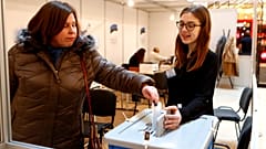 A woman casts her vote during advanced voting in Tallin