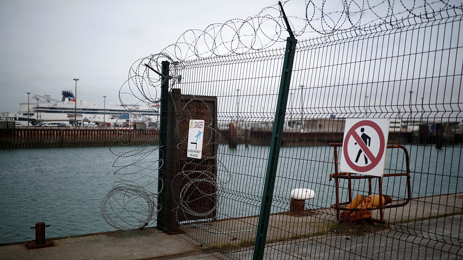 P&O cross-Channel ferry seen through razor wired security fence in Calais. 