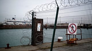 P&O cross-Channel ferry seen through razor wired security fence in Calais. 