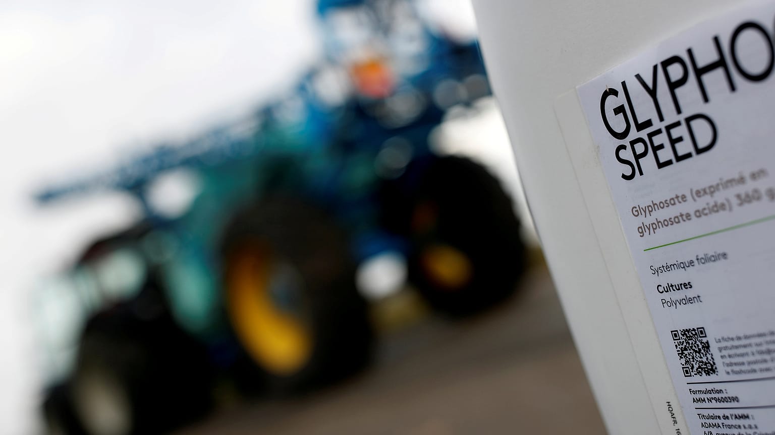 File picture: A can of glyphosate weedkiller is seen in front of a tractor 