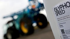 File picture: A can of glyphosate weedkiller is seen in front of a tractor 