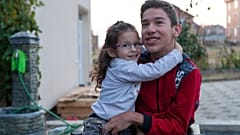 14-year-old Rijad Mehmeti, who has cerebal palsy, with his sister