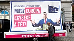 A pedestrian walks past an anti-Hungary's PM Orban billboard in Brussels