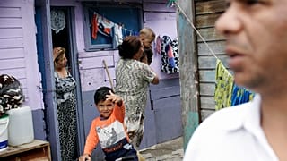 A Roma family is seen in the Cesmin Lug Camp outside Trepca mine, on the ou