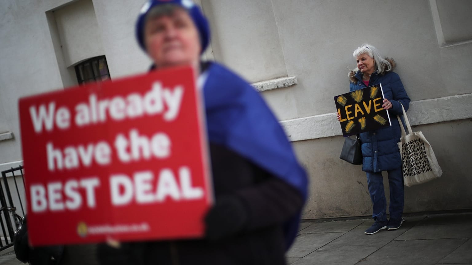 An anti-Brexit and a Pro-Brexit protester hold up signs in London, Britain 