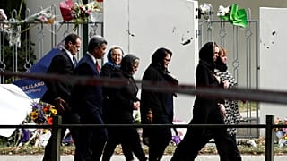 Jacinda Ardern walks past Al-Noor mosque as she arrives for Friday prayers 