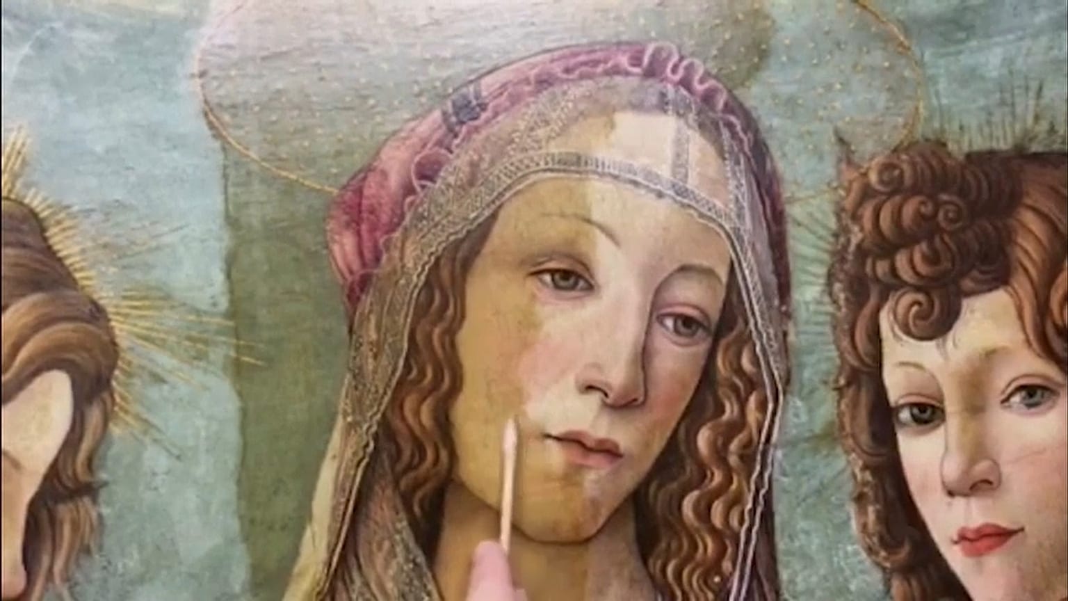 Art restorer working on a workshop version of Botticelli's painting 