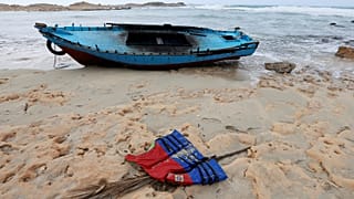 A boat used by migrants is seen near the western town of Sabratha