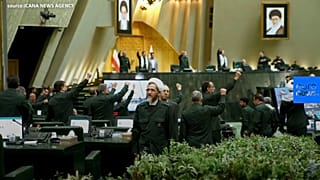 Iranian lawmakers wear Revolutionary Guards uniforms to parliament
