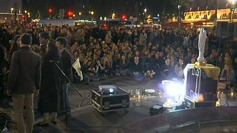 Catholics sing hymns during twilight parade after Notre-Dame fire
