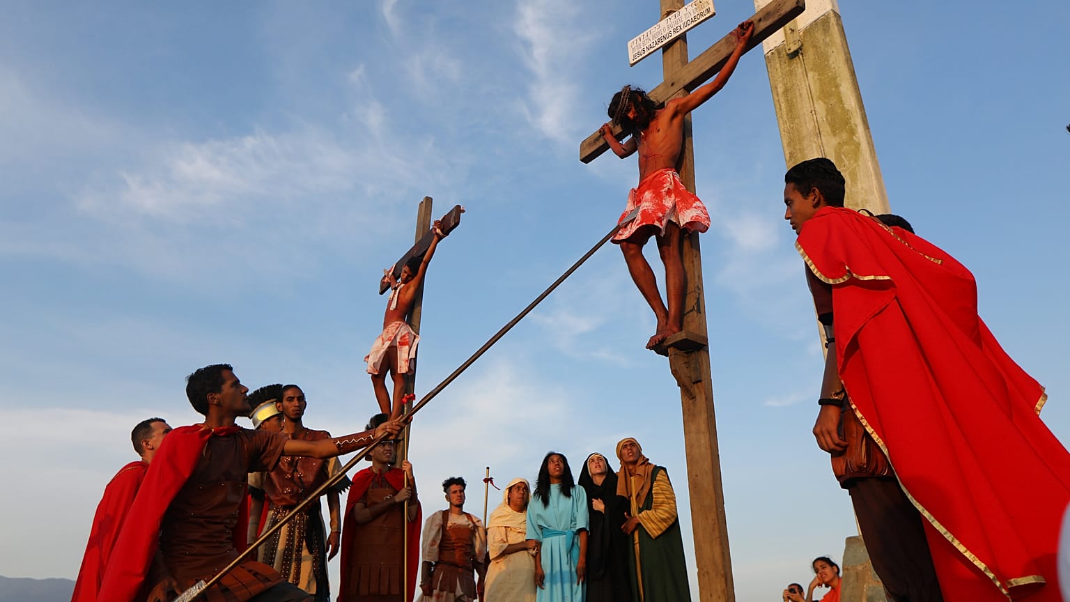 Actors are seen on the cross in a re-enactment of the crucifixion of Jesus 