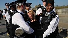 A climate change activist is detained during the London protest