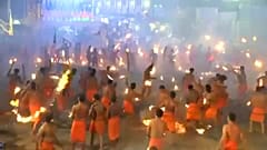 Hindu devotees throw flaming torches during Indian fire festival
