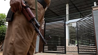 Policeman stands guard outside sealed office of National Tawheed Jamaath