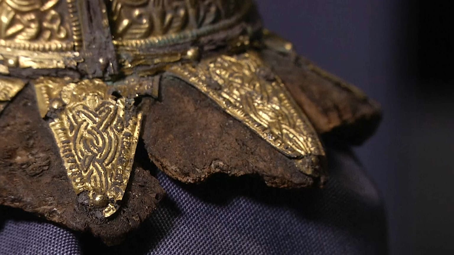 Items unearthed include a golden belt buckle and the remnants of a harp