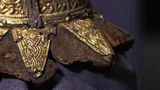 Items unearthed include a golden belt buckle and the remnants of a harp