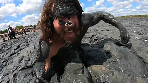 UK: Mud race competitors wade to the finish line