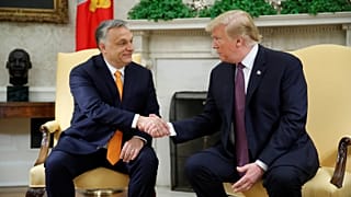 Trump shakes Orban's hands in the Oval Office.