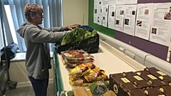 “Sarah Nor,” a volunteer and pantry user at the Goodwin Community Pantry.
