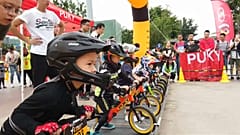Young riders sprint on balance bike course in southwest China