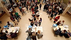 People cast their votes at a ballot station