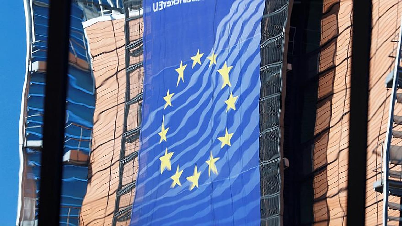EU Commission HQ is reflected in the windows of the EU Council building 