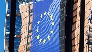 EU Commission HQ is reflected in the windows of the EU Council building 