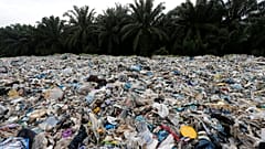 Plastic waste is piled outside an illegal recycling factory in Malaysia