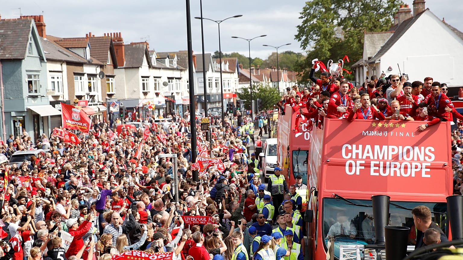 Liverpool's team bus travels past fans during the parade 
