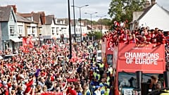 Liverpool's team bus travels past fans during the parade 