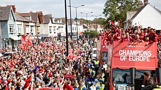 Liverpool's team bus travels past fans during the parade 