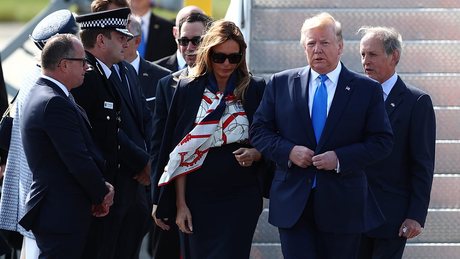 Police officers and Guardsman move past U.S. and British flags