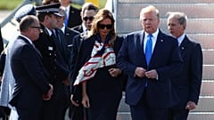 Police officers and Guardsman move past U.S. and British flags