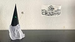 Capirote of Holy Week made with paper and a Koranic inscription