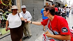 An international aid worker hands out condoms