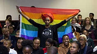 An activist holds up a rainbow flag to celebrate inside Botswana High Court