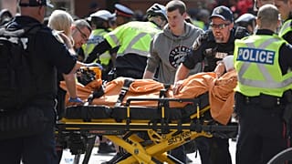 A woman is taken away by ambulance after reports of shots fired in Toronto, Canada June 17, 2019.