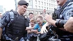 Women react as members of Russia's National Guard detain participants of a rally in support of Russian investigative journalist Ivan Golunov in Moscow