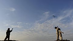 Afghan boys engaging in child play flying kites in Kabul, Afghanistan
