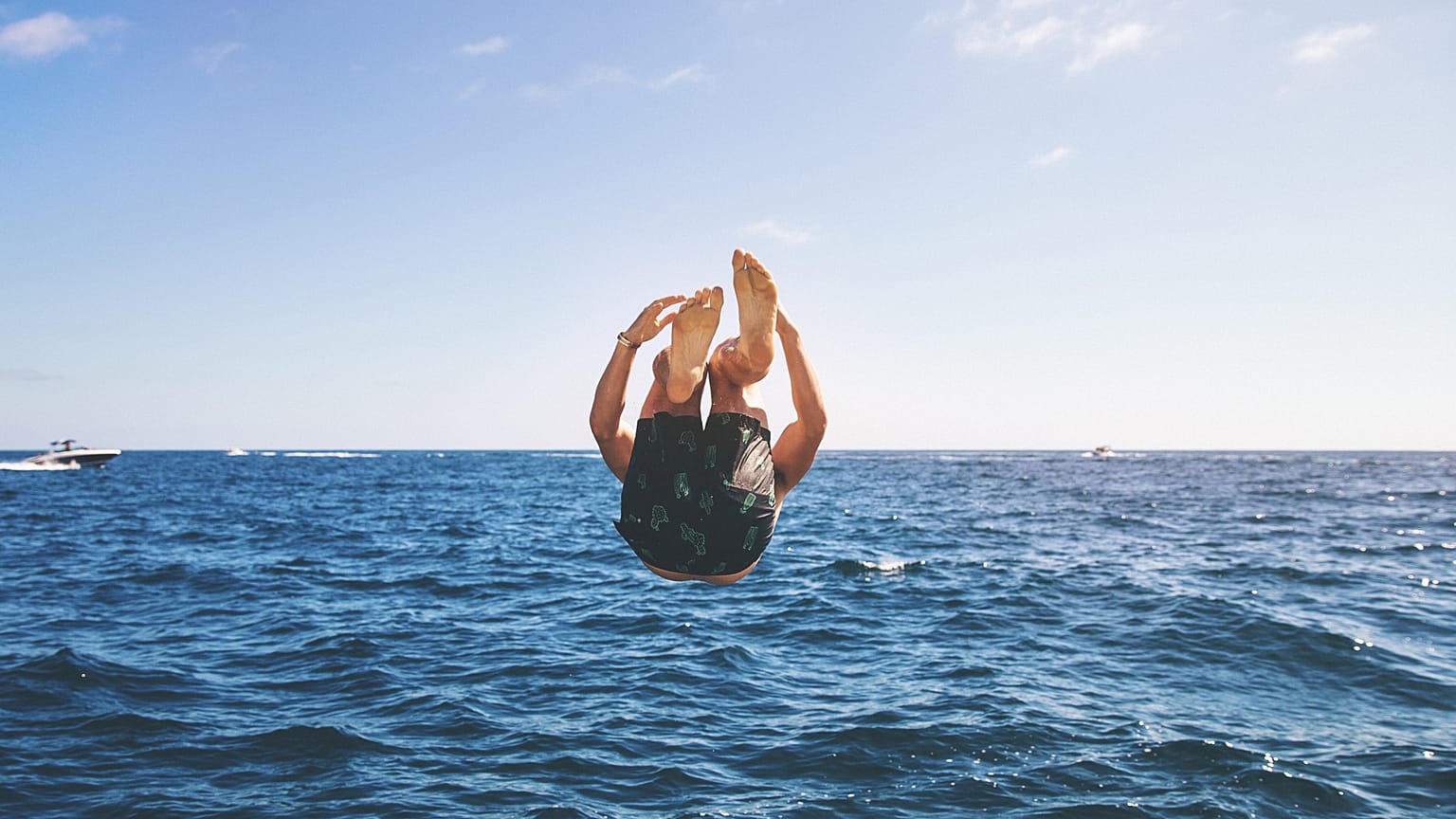Men's swimwear, man jumping into the sea