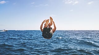 Men's swimwear, man jumping into the sea