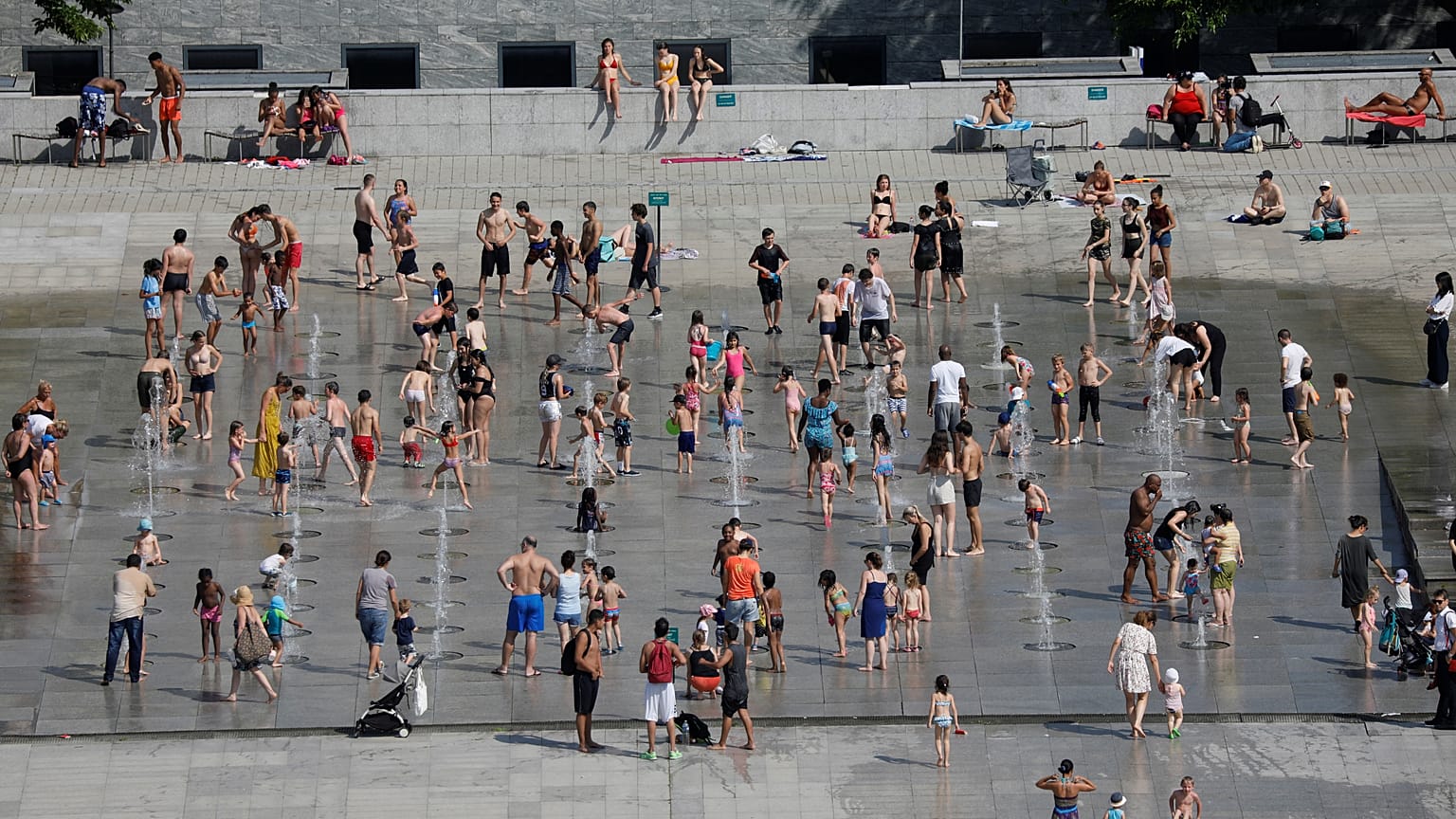 People cool off in the fountains at the Andre Citroen park in Paris as a heatwave hit much of the country, France, June 25, 2019. 