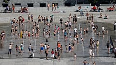 People cool off in the fountains at the Andre Citroen park in Paris as a heatwave hit much of the country, France, June 25, 2019. 